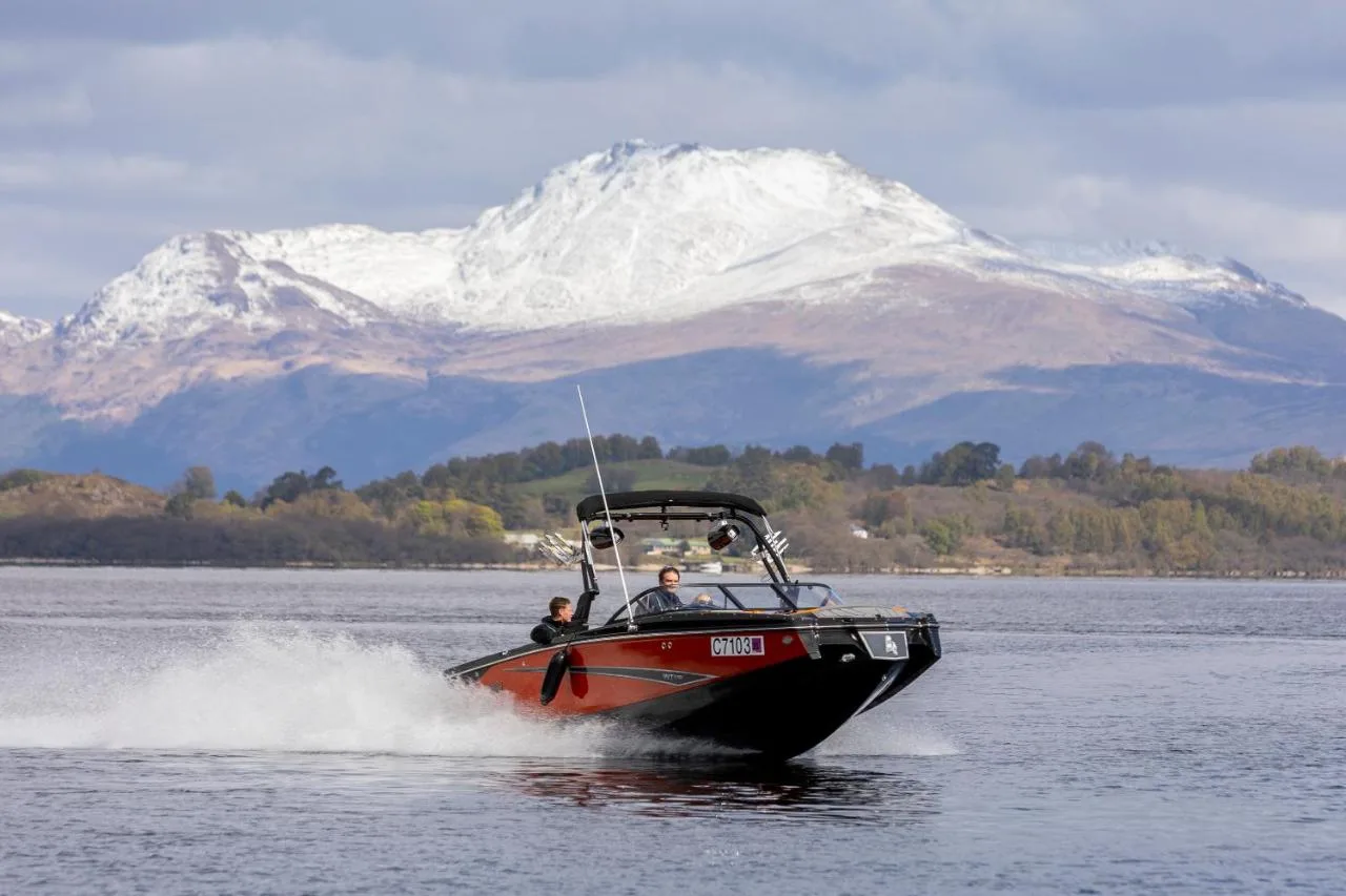 Hotel speedboat on Loch Lomond with Ben Lomond behind
